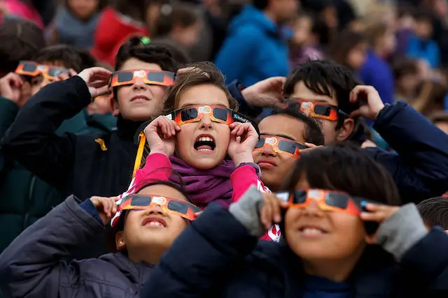 Students in Spain using protective glasses to view a partial eclipse in March, 2015